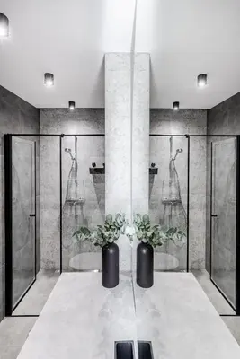 a bathroom with two vases with plants on a table at Luxurious Apartment in Vilnius Old Town by Reside Baltic in Vilnius