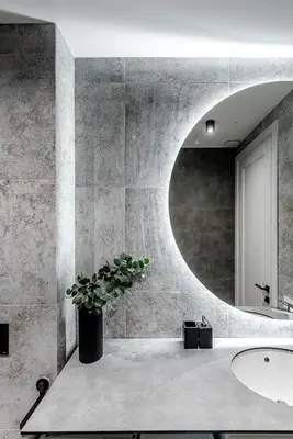 a bathroom with a round mirror and a sink at Luxurious Apartment in Vilnius Old Town by Reside Baltic in Vilnius