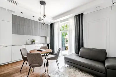 a living room with a couch and a table and chairs at Luxurious Apartment in Vilnius Old Town by Reside Baltic in Vilnius