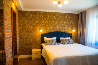 a bedroom with a bed with a blue head board at LYRA63 Large 80sq m TOP 14 floor in Šiauliai