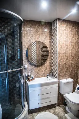 a bathroom with a shower and a sink and a toilet at LYRA63 Large 80sq m TOP 14 floor in Šiauliai