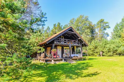 a small cabin in the middle of a field at Namelis Rudnios kaime “Nykštukas” in Rudnia
