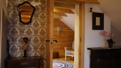 an open door to a room with a staircase at Namelis Rudnios kaime “Nykštukas” in Rudnia