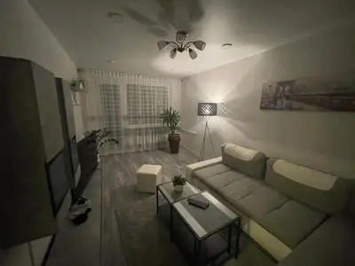 a living room with a couch and a table at Ateities 3044 Self CHECK In in Panevėžys