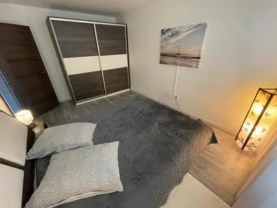 a bedroom with a large bed and a window at Ateities 3044 Self CHECK In in Panevėžys