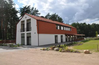 a large building with a red and white at Kamanos in Utena