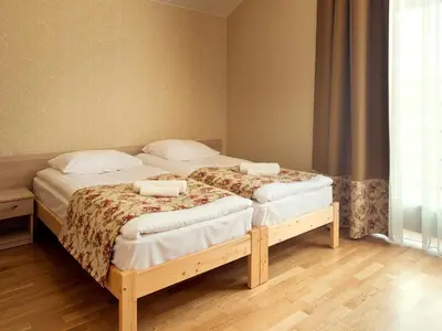 a bedroom with two twin beds in a room at Kamanos in Utena