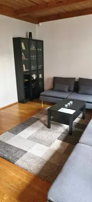 a living room with a couch and a coffee table at Laurentroom Townhouse in Ukmergė