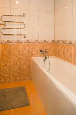 a bathroom with a tub and a shower at Laurentroom Townhouse in Ukmergė