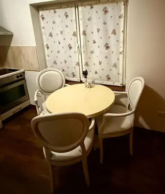 a table and chairs in a kitchen with a window at CENTRO House in Alytus