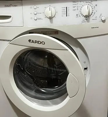 a white washing machine sitting in a room at CENTRO House in Alytus