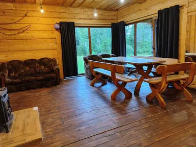 a living room with a table and chairs and a couch at Piglet house in Alytus
