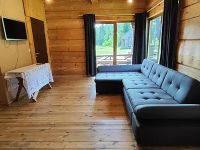 a living room with a couch and a table at Piglet house in Alytus