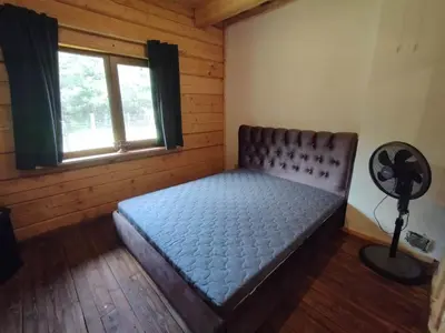 a bedroom with a bed in a room with a window at Piglet house in Alytus