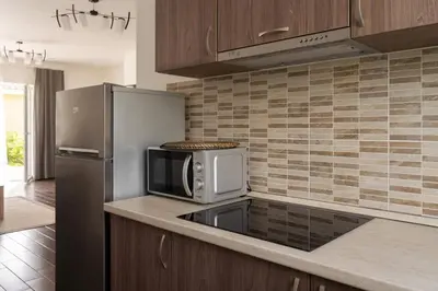 a kitchen with a microwave and a refrigerator at 1 House Between two lakes in Vilnius
