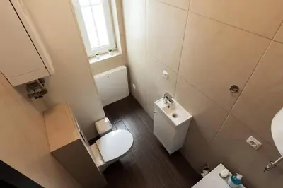 a small bathroom with a toilet and a sink at 1 House Between two lakes in Vilnius