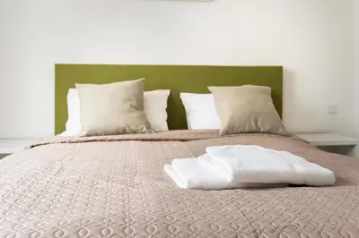 a bed with two white pillows on top of it at 1 House Between two lakes in Vilnius
