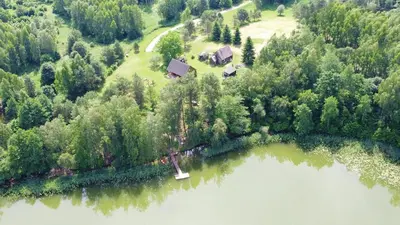 an aerial view of a house next to a lake at Sodyba “Rita” in Mėčiūnai
