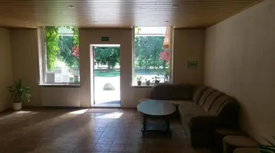 a living room with a couch and a table at Berzu aleja in Birštonas