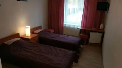 a hotel room with two beds and a window at Berzu aleja in Birštonas