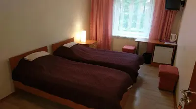 a hotel room with two beds and a window at Berzu aleja in Birštonas