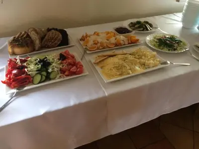 a table with several plates of food on it at Liškiavos vienuolyno ansamblis in Liškiava