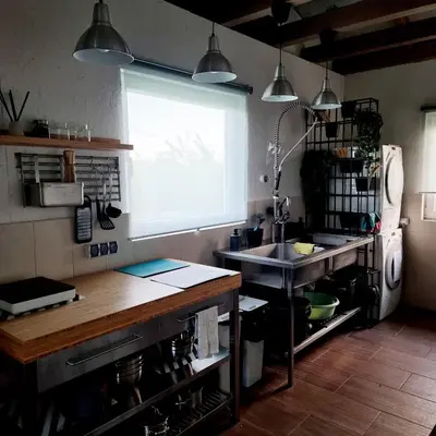 a kitchen with a sink and a window at Camp Genys in Jurbarkas