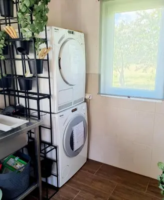 a washing machine in a room with a window at Camp Genys in Jurbarkas