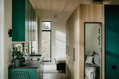 a kitchen with a sink and a mirror in a room at Birštonas Tiny Hemp House in Birštonas