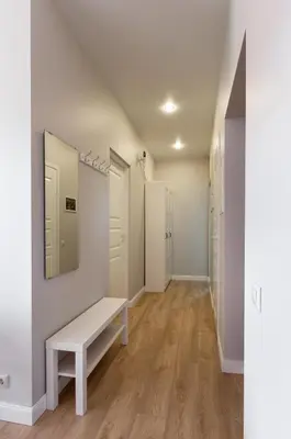 a dressing room with a bench and a mirror at à la fontaine in Druskininkai