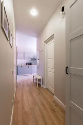 an empty hallway with a door and a kitchen at à la fontaine in Druskininkai