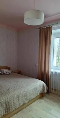 a bedroom with a bed and a large window at The good stay in Šiauliai