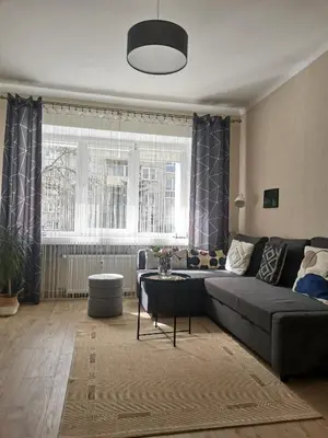 a living room with a couch and a table at The good stay in Šiauliai