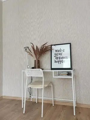 a white desk with a chair next to a wall at The good stay in Šiauliai
