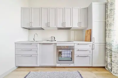 a kitchen with white cabinets and an oven at Lovely, Best View Apartment, Vilnius City Centre in Vilnius