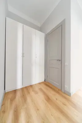 an empty white room with a door and wooden floors at Lovely, Best View Apartment, Vilnius City Centre in Vilnius