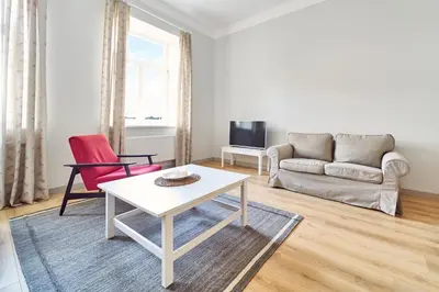 a living room with a white table and a couch at Lovely, Best View Apartment, Vilnius City Centre in Vilnius
