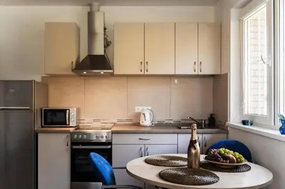 a kitchen with a table with a bottle of wine at 3 Apartment Between two lakes in Vilnius