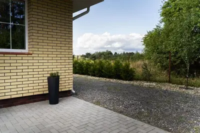 a black trash can sitting on the side of a house at 3 Apartment Between two lakes in Vilnius