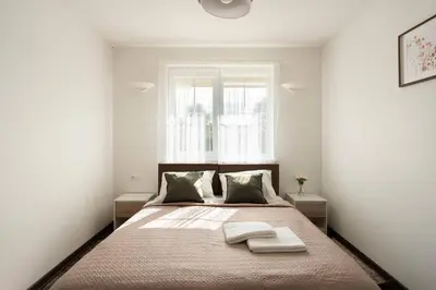 a bedroom with a bed with two towels on it at 4 Apartment Between two lakes in Vilnius