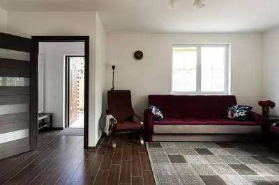 a living room with a red couch and a chair at 4 Apartment Between two lakes in Vilnius