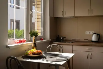 a kitchen with a table with a bowl of fruit on it at 4 Apartment Between two lakes in Vilnius