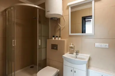 a bathroom with a shower and a toilet and a sink at 4 Apartment Between two lakes in Vilnius