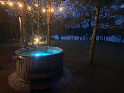 a trash can with lights in a park at night at Kedras Glamping - Pod tipo nameliai in Prapuntai