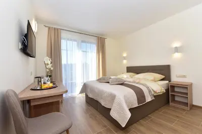 a bedroom with a bed and a desk and a window at Panorama in Trakai