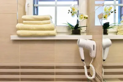 a hairdryer hanging on a wall in a bathroom at Panorama in Trakai