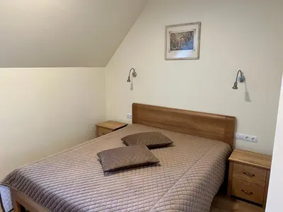 a bedroom with a bed with two pillows on it at Pakėvio dvaras - Pakevis manor in Kelmė