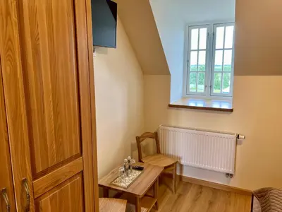 a small room with a table and a window at Pakėvio dvaras - Pakevis manor in Kelmė