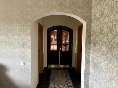 a hallway with a black door and a tile floor at Pakėvio dvaras - Pakevis manor in Kelmė