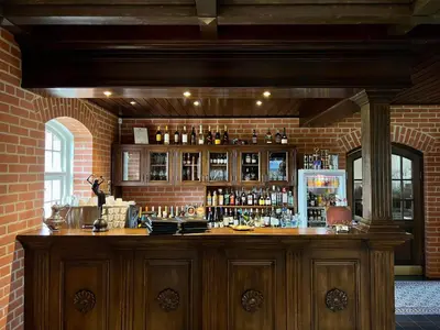 a bar in a brick wall with a bar counter at Pakėvio dvaras - Pakevis manor in Kelmė